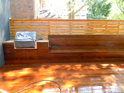 A newly finished outdoor kitchen on a wooden patio