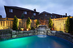 Stone Work & Landscaping Lighting Around a Pool in the Backyard